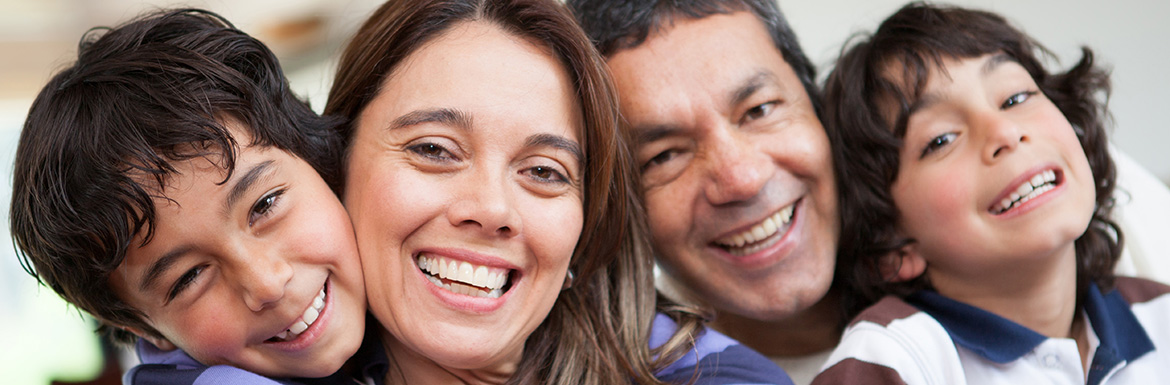 A smiling family glad they chose Winning Smile Dentistry